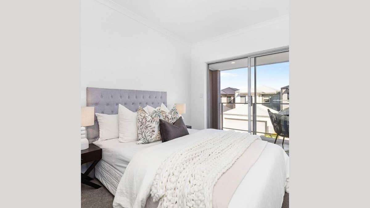 bed with white comforters in modern home
